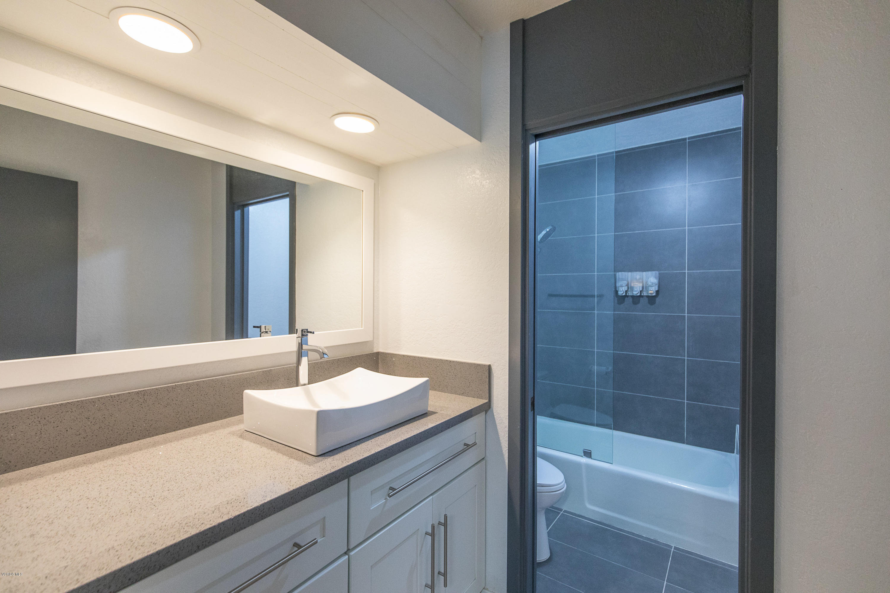 2001 Roscomare Road Los Angeles, CA 90077 - Photo 26 of 52 a bathroom with a granite countertop sink a toilet and shower