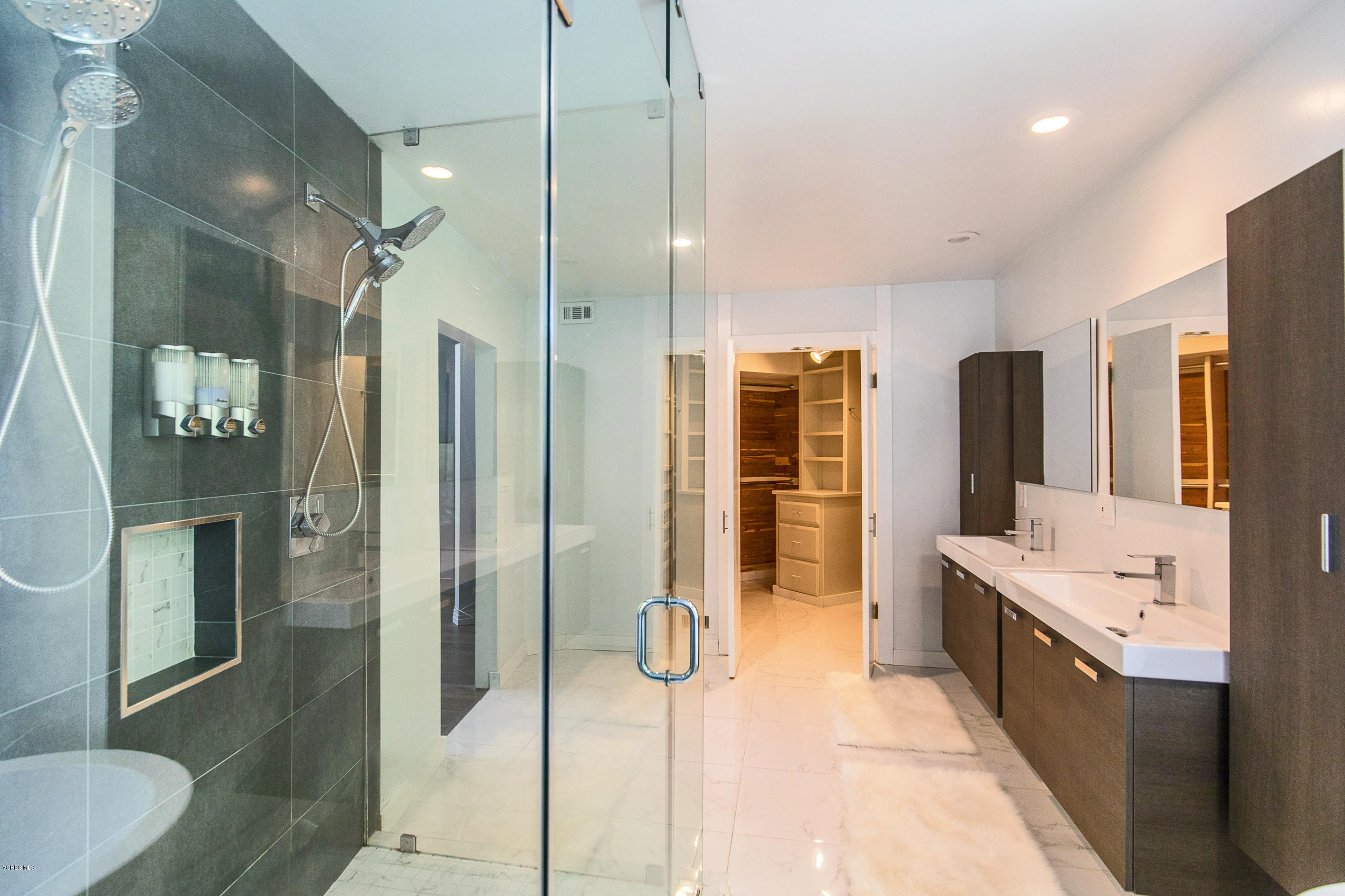 2001 Roscomare Road Los Angeles, CA 90077 - Photo 32 of 52 a bathroom with a tub sink shower and mirror