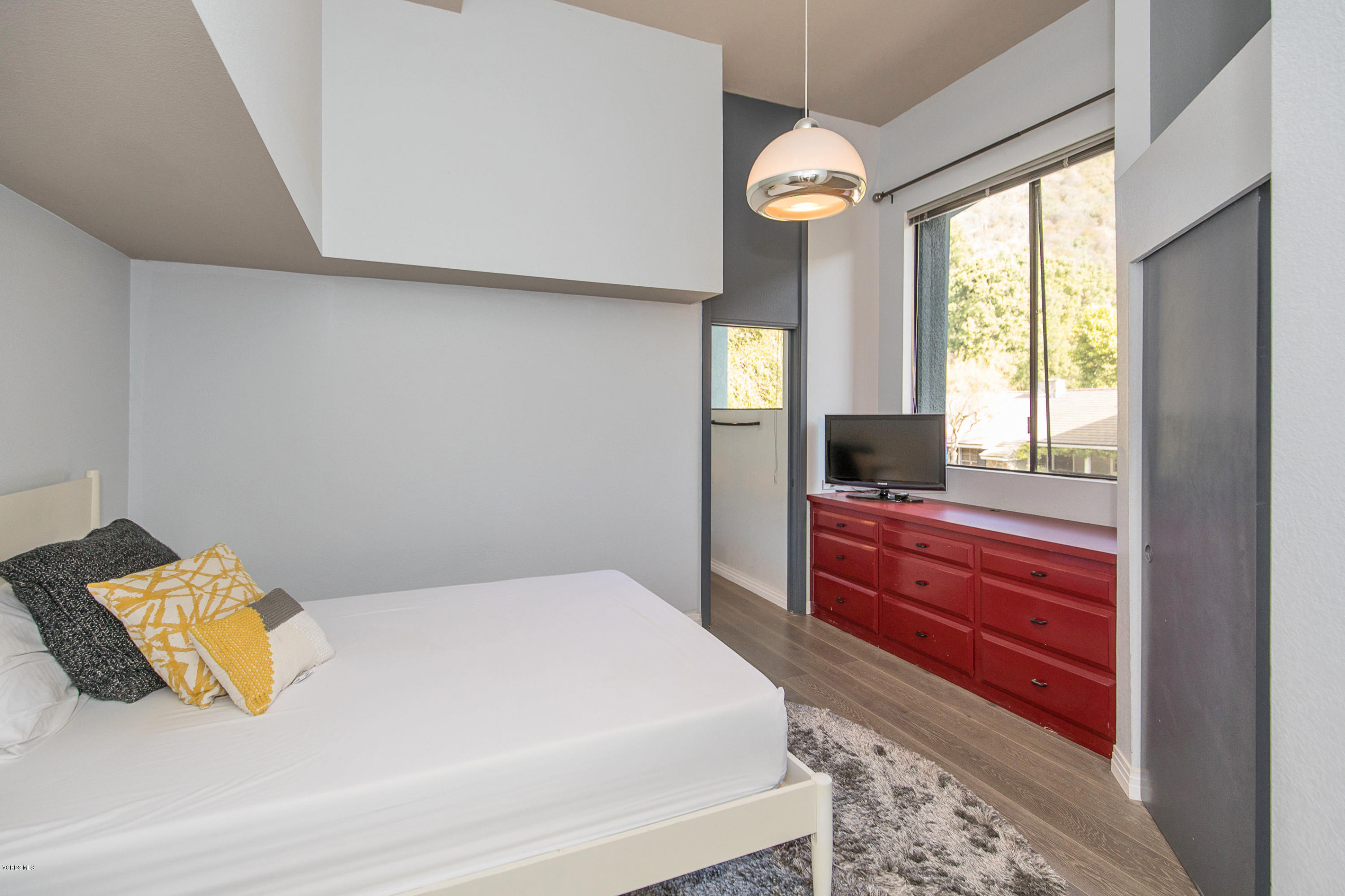 2001 Roscomare Road Los Angeles, CA 90077 - Photo 40 of 52 a bedroom with a large bed and a large window