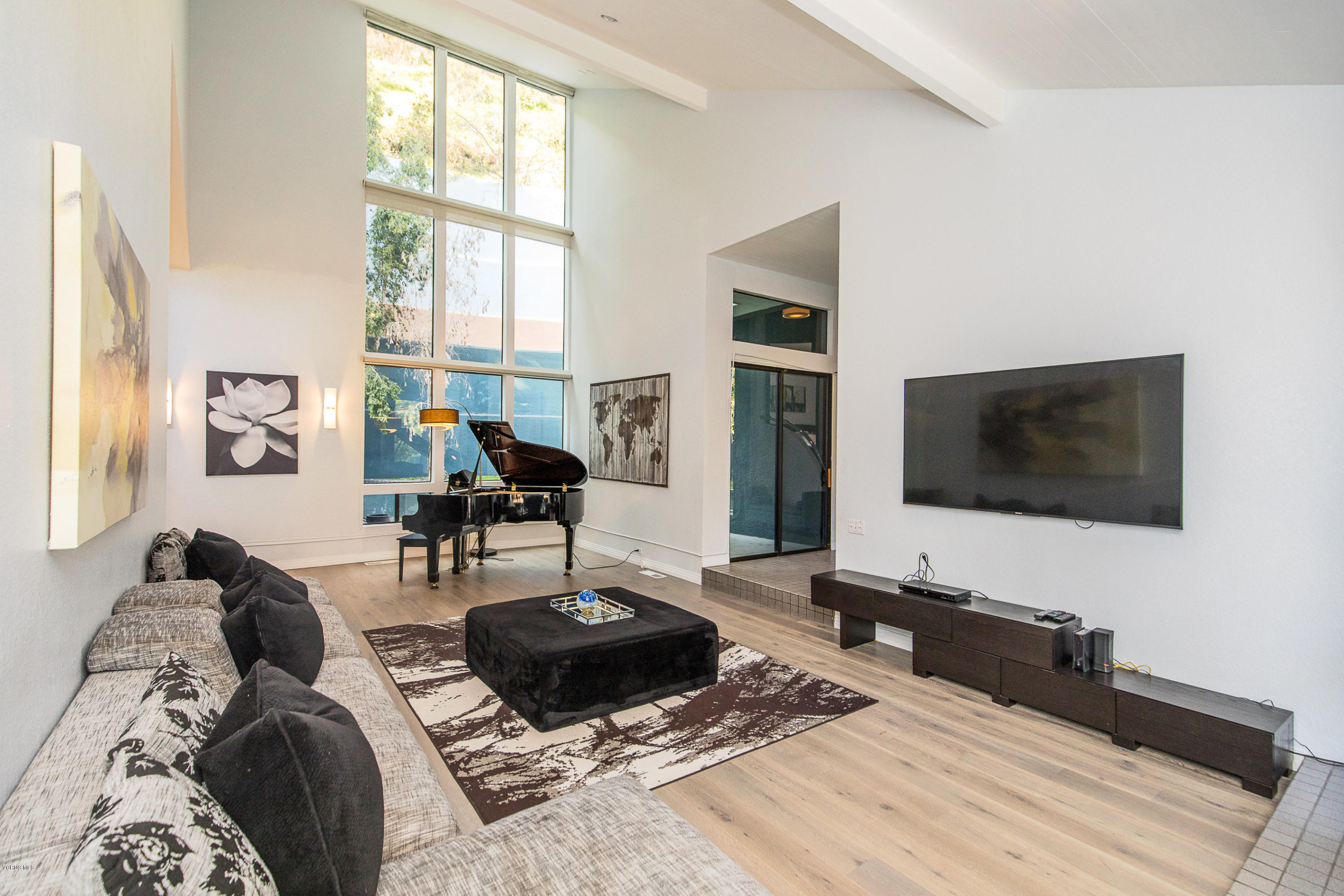 2001 Roscomare Road Los Angeles, CA 90077 - Photo 7 of 52 a living room with furniture and a flat screen tv