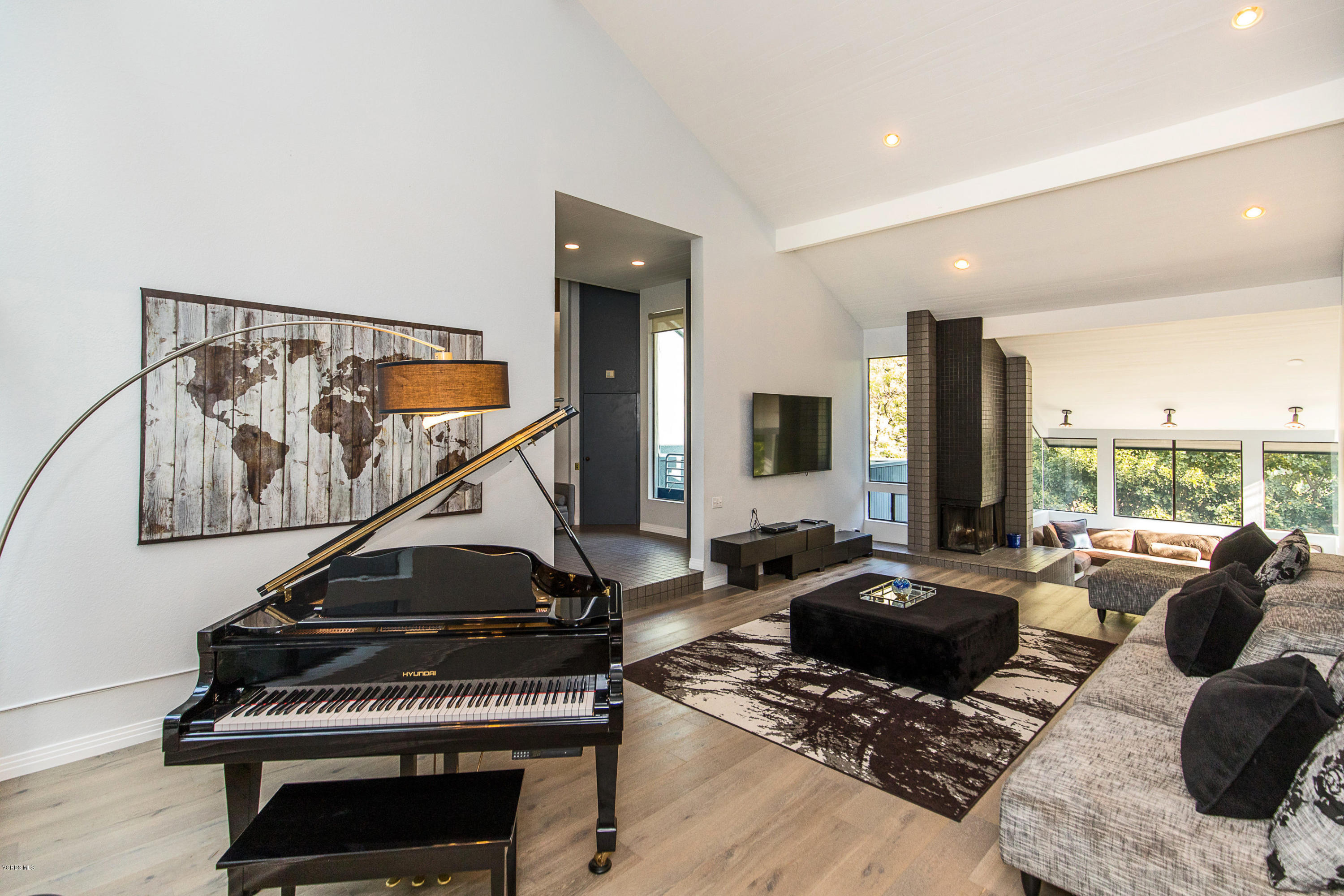 2001 Roscomare Road Los Angeles, CA 90077 - Photo 8 of 52 a living room with furniture a rug and a window