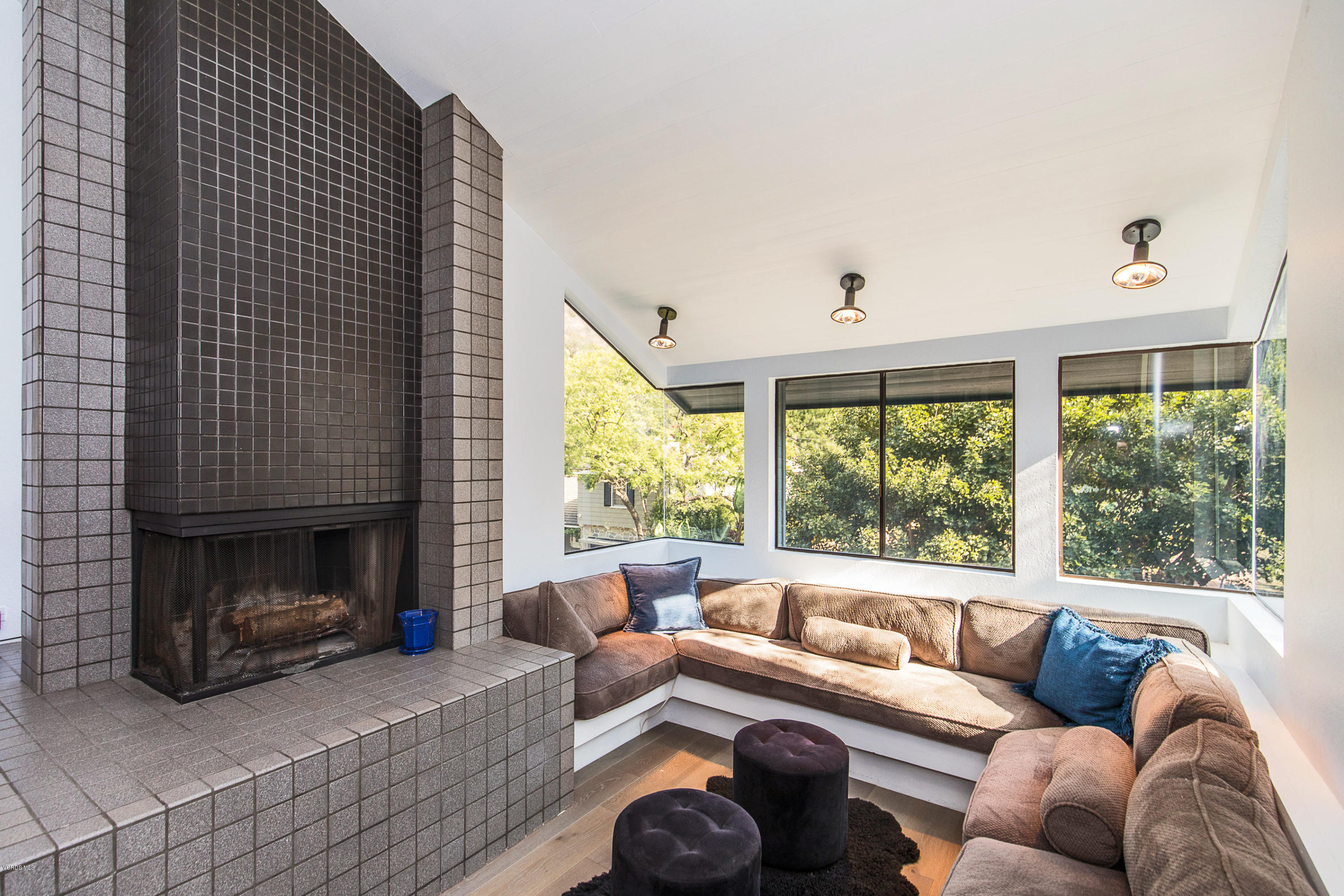 2001 Roscomare Road Los Angeles, CA 90077 - Photo 10 of 52 a living room with furniture a large window and a fireplace