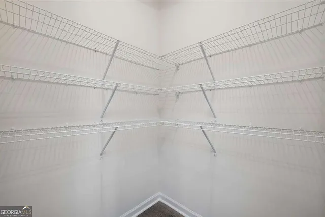a view of kitchen with kitchen island stainless steel appliances wooden floor and a counter top space