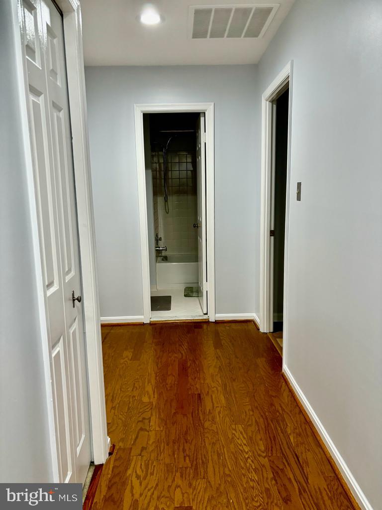 6803 Wild Rose Court Springfield, VA 22152 - Photo 41 of 49 an empty room with wooden floor and windows