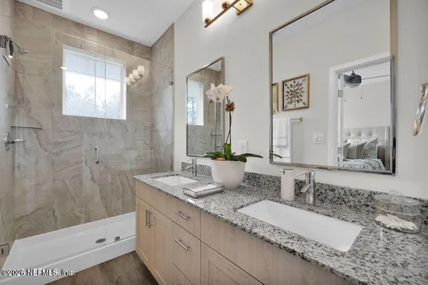 a bathroom with a double vanity sink and a mirror