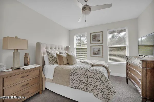 a bedroom with a large bed and a window
