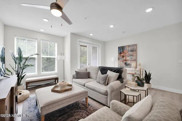 a living room with furniture and a large window
