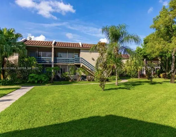 a view of a house with a backyard