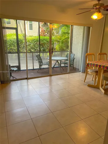 a view of an empty room with a sliding door and glass windows