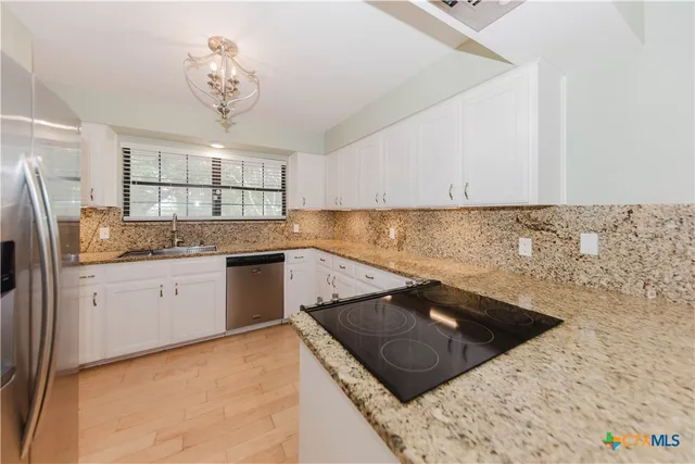 a kitchen with a stove a sink and a refrigerator