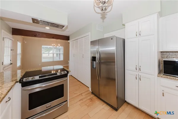 a bedroom with furniture and a window