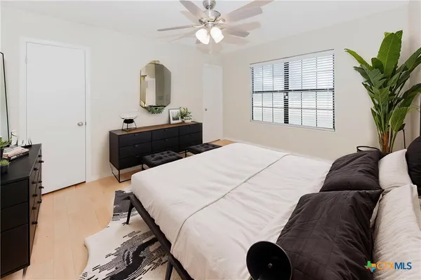 a bedroom with a bed and a television