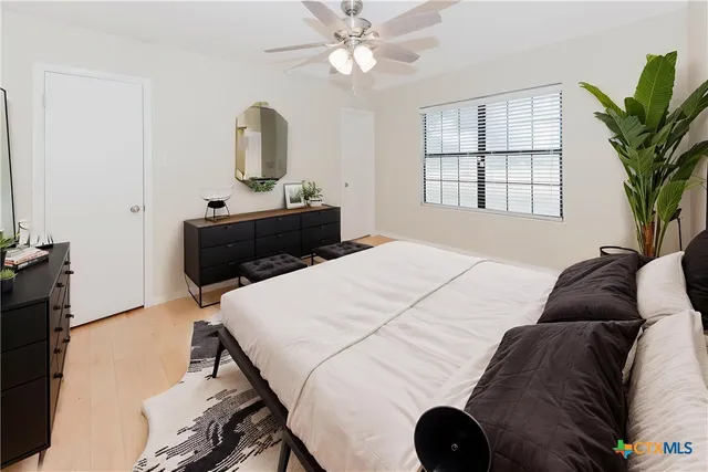 a bedroom with a bed and a television