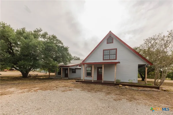 a view of a house with a backyard