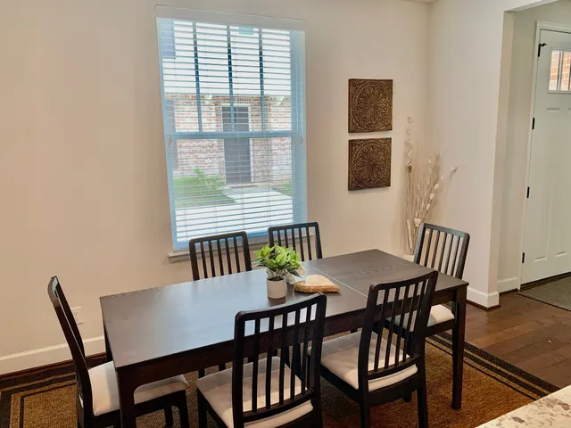 a view of a dining room with furniture and window
