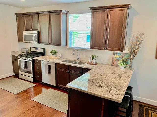 a kitchen with a sink stove and microwave