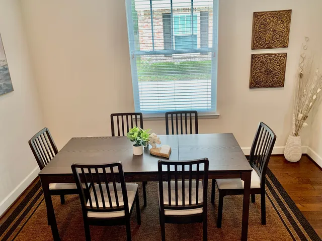 a view of a dining room with furniture and wooden floor