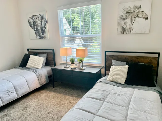 a bedroom with a large bed and a window