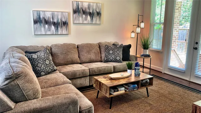 a living room with furniture a rug and a window