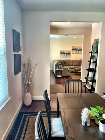 a living room with furniture flowerpot and wooden floor