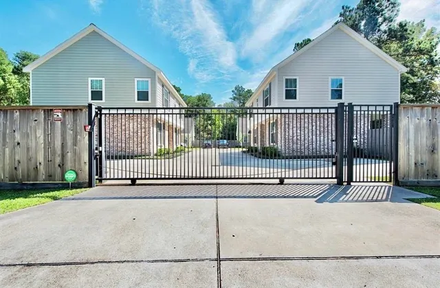 a view of a house with a wooden fence