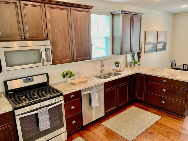a kitchen with a stove microwave and sink