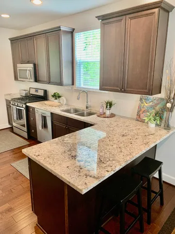 a kitchen with a stove a sink and a refrigerator
