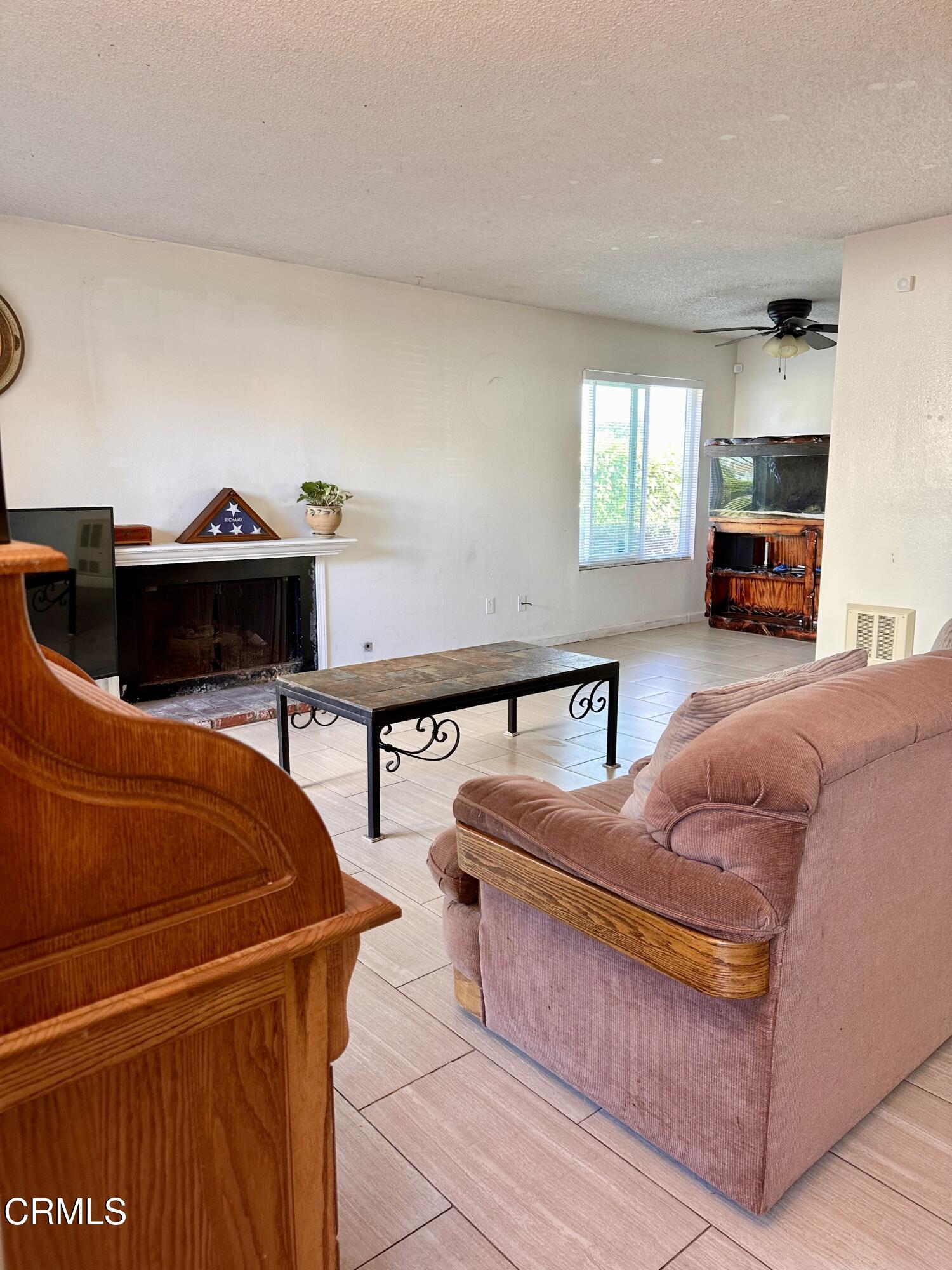 5212 Jefferson Square Oxnard, CA 93033 - Photo 4 of 12 a living room with furniture a rug and a window