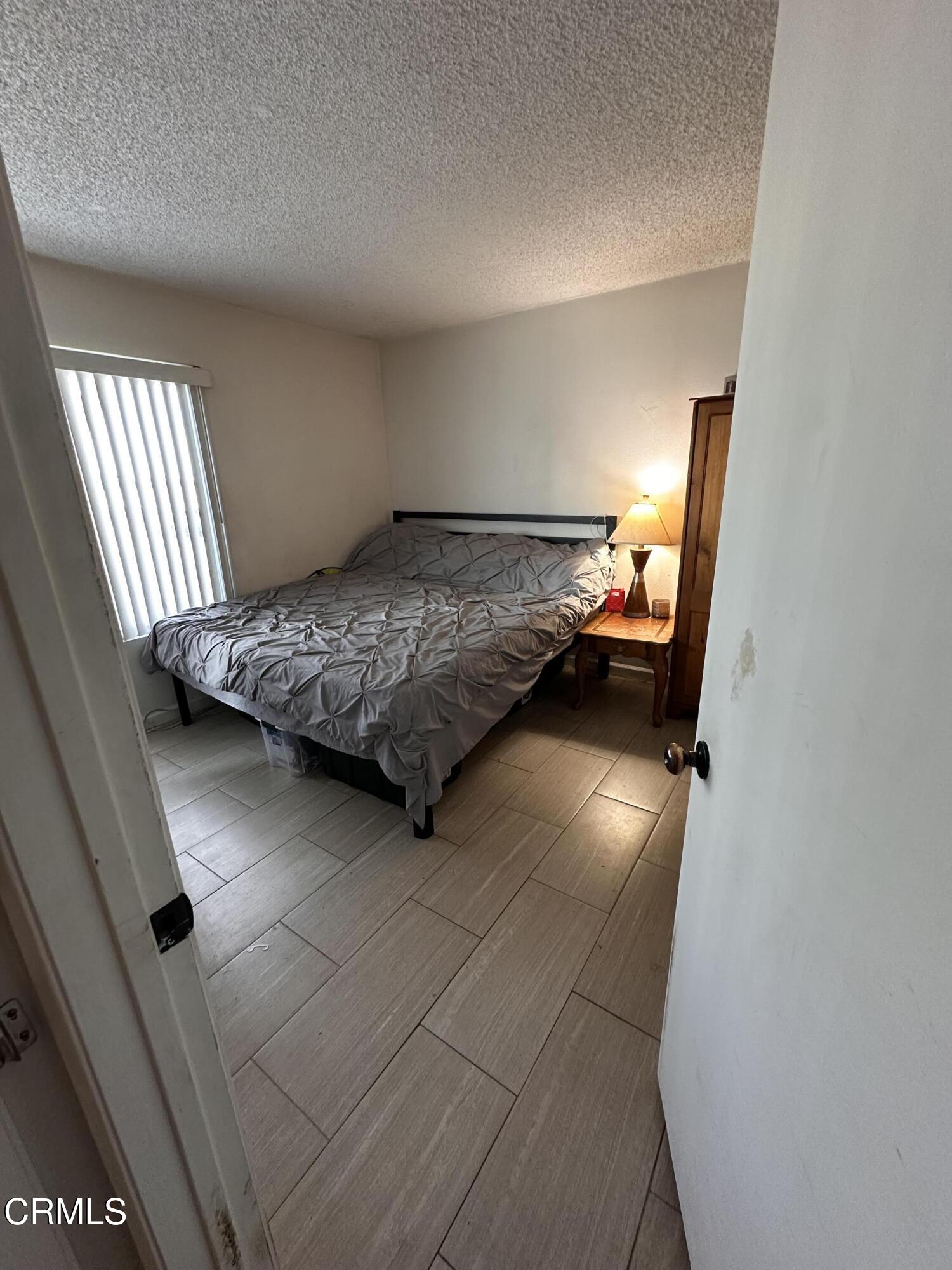 5212 Jefferson Square Oxnard, CA 93033 - Photo 8 of 12 a bedroom with a bed and window