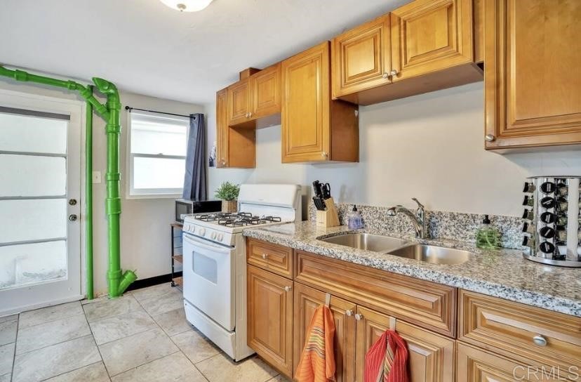 4377 Rialto Street San Diego, CA 92107 - Photo 3 of 15 a kitchen with granite countertop a sink stainless steel appliances a counter space and cabinets