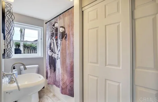 a bathroom with a sink a toilet and a mirror