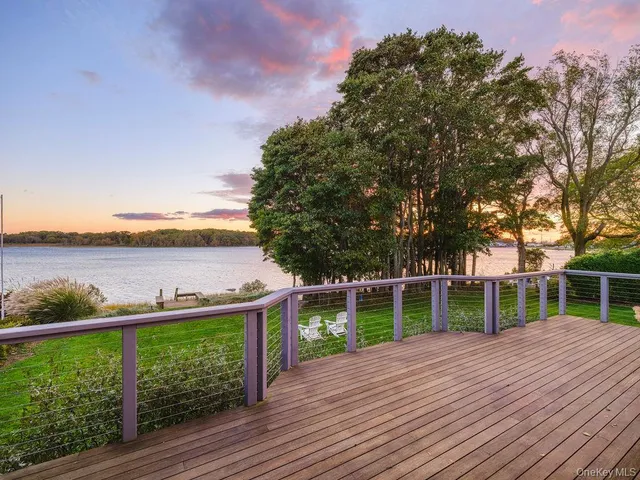 a balcony with wooden floor and fence
