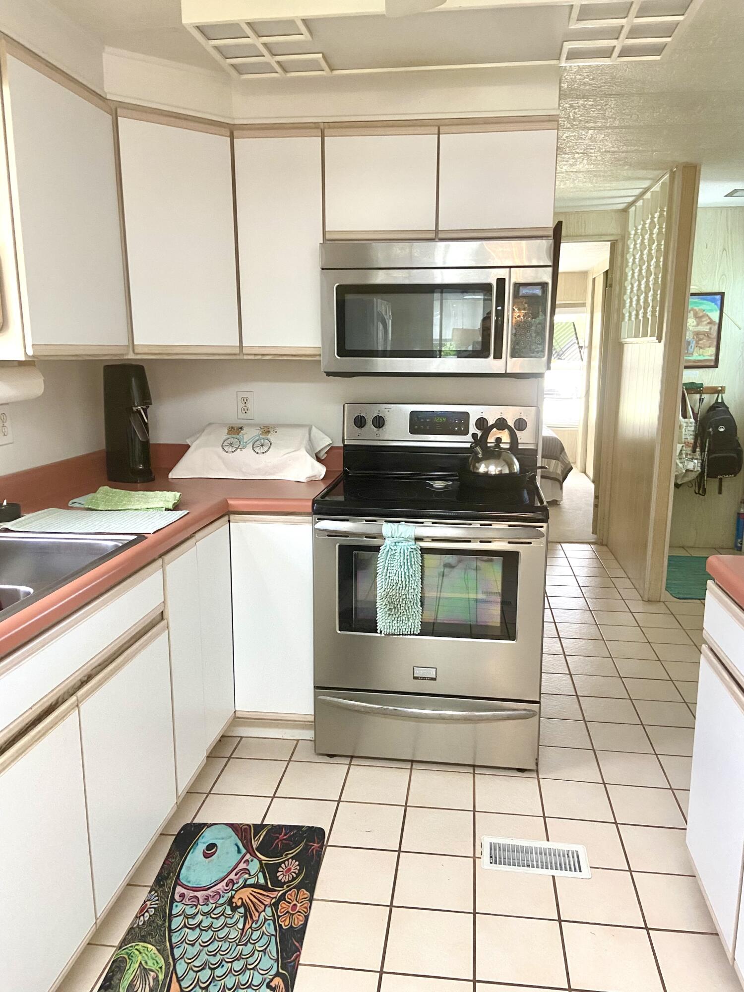 29 Quintana Roo Lane Port St. Lucie, FL 34952 - Photo 13 of 51 a kitchen with stainless steel appliances a stove a sink and a microwave