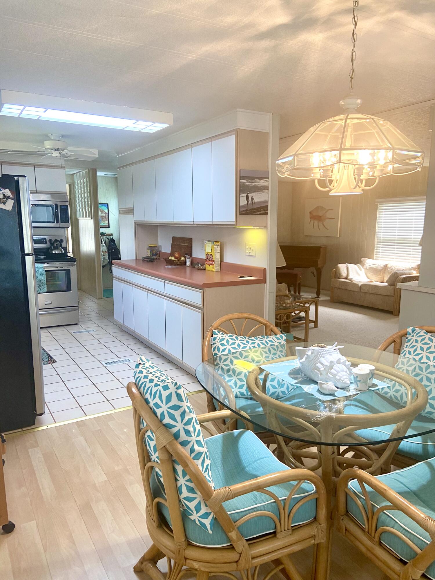 29 Quintana Roo Lane Port St. Lucie, FL 34952 - Photo 20 of 51 a kitchen with stainless steel appliances kitchen island granite countertop a table and chairs
