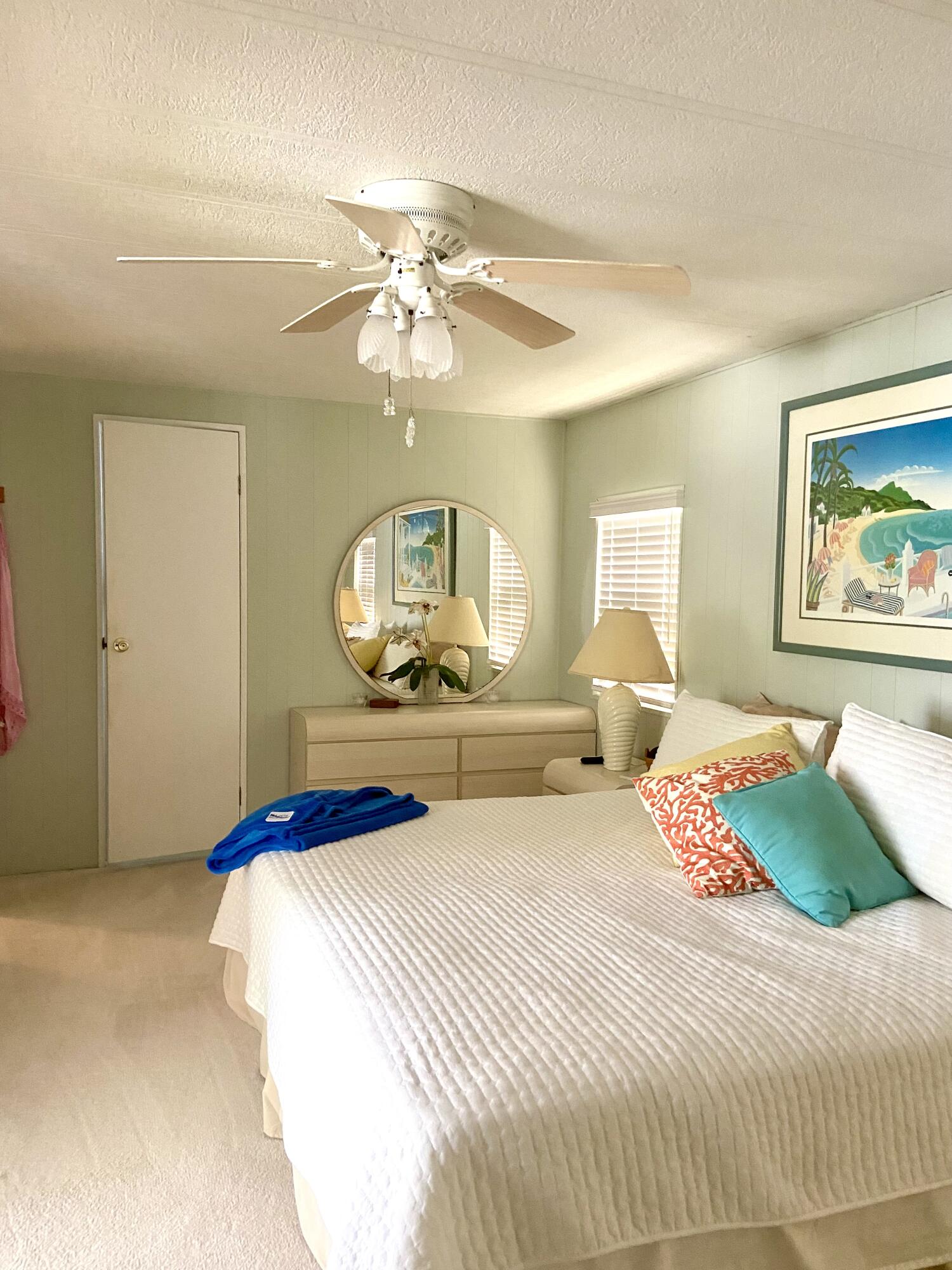 29 Quintana Roo Lane Port St. Lucie, FL 34952 - Photo 30 of 51 a bedroom with a large bed and a chandelier