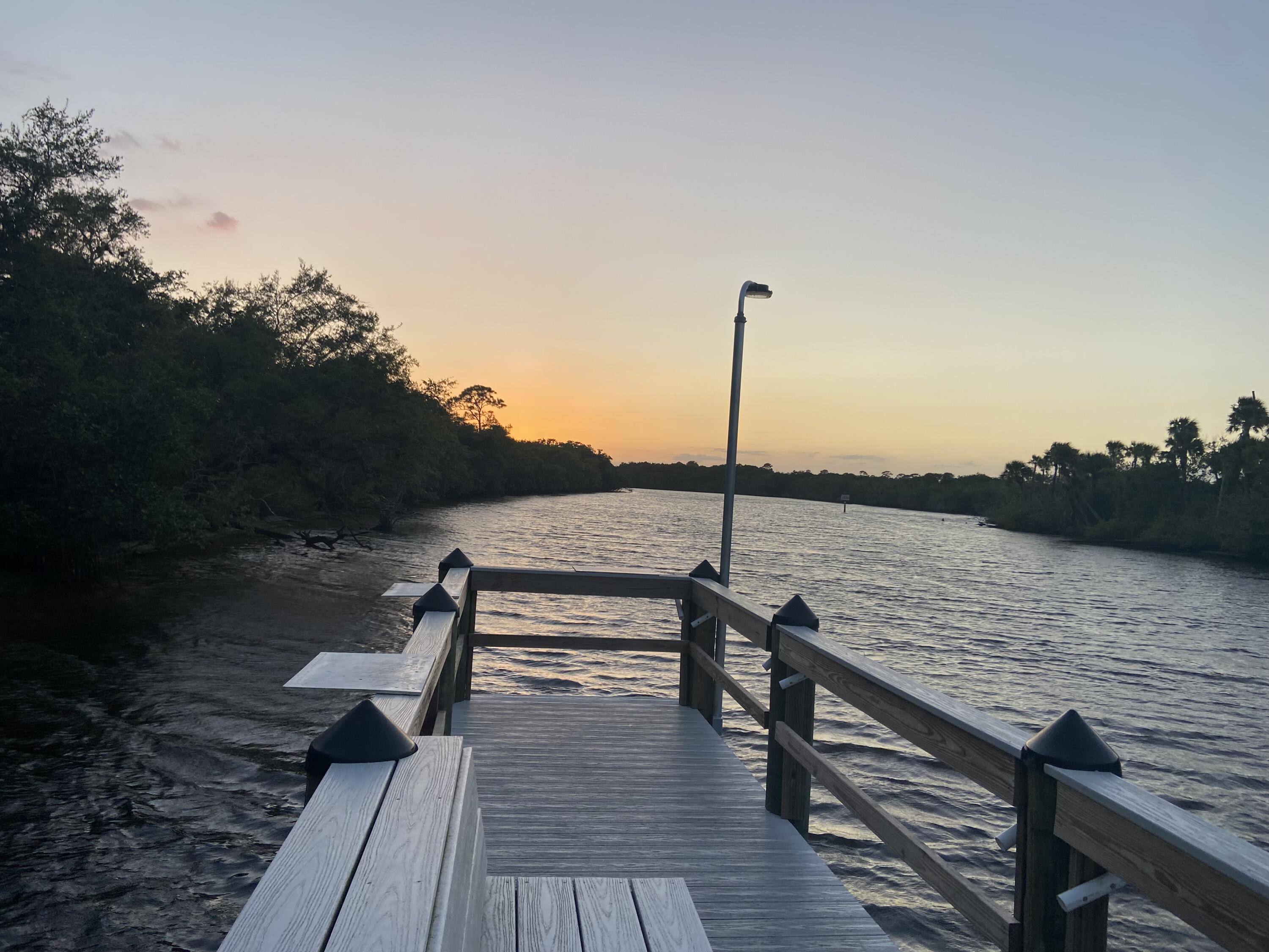 29 Quintana Roo Lane Port St. Lucie, FL 34952 - Photo 35 of 51 a view of a lake with a bench