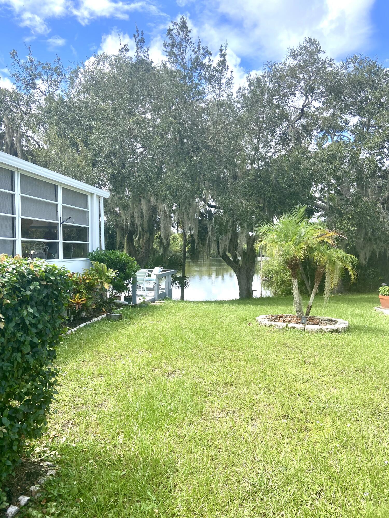 29 Quintana Roo Lane Port St. Lucie, FL 34952 - Photo 4 of 51 a view of a backyard with a garden and trees