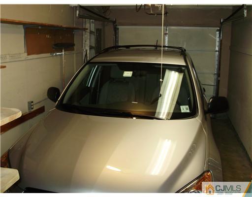 48 Woodbrook Road Edison, NJ 08820 - Photo 2 of 11 a car parked in front of door