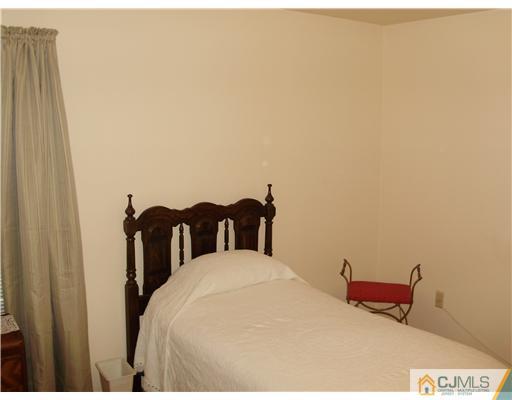 48 Woodbrook Road Edison, NJ 08820 - Photo 4 of 11 a bed sitting in a bedroom next to a bathroom