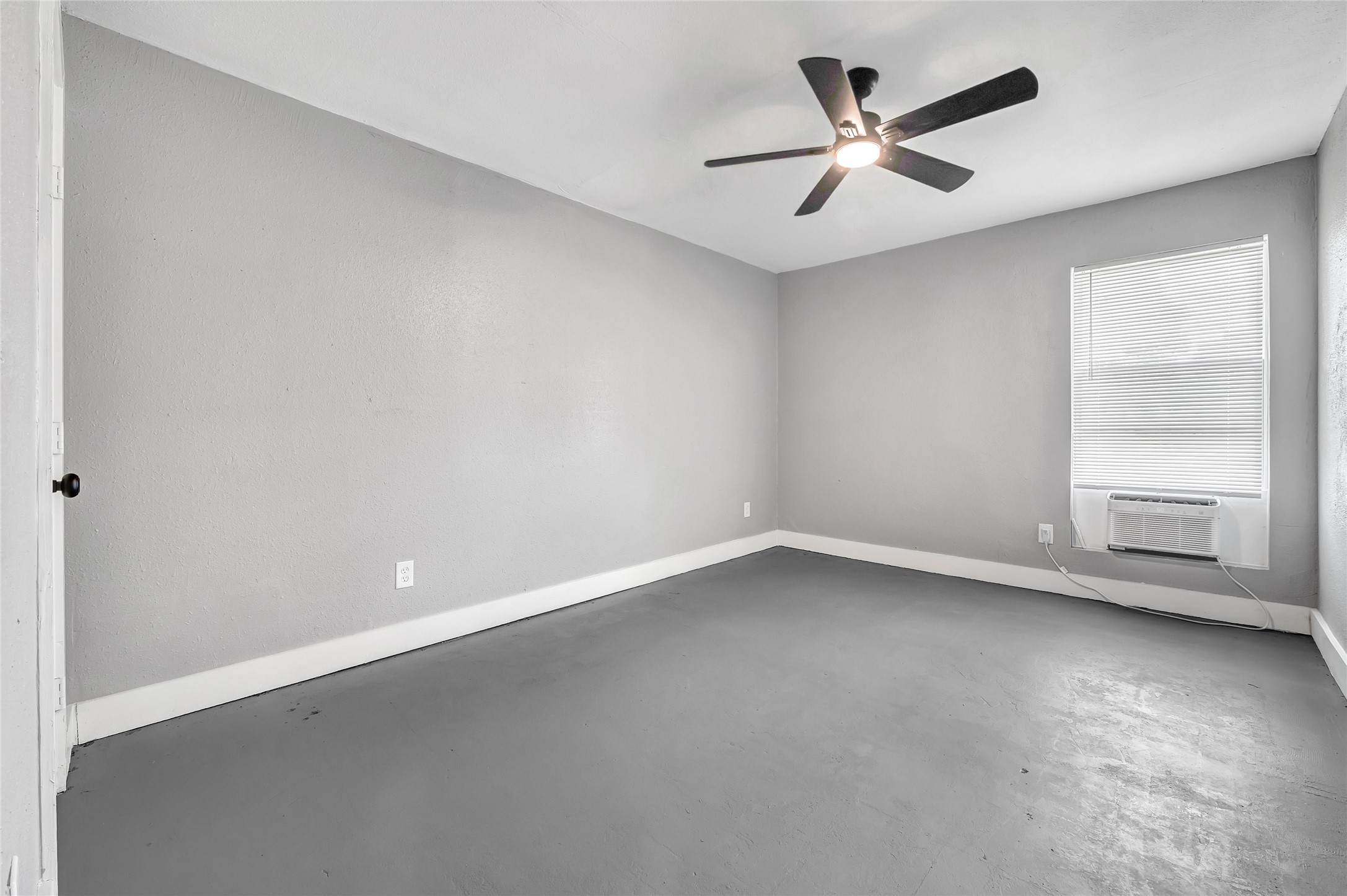 3802 Dabney Street, Unit 3 Houston, TX 77026 - Photo 11 of 13 an empty room with a window and a ceiling fan