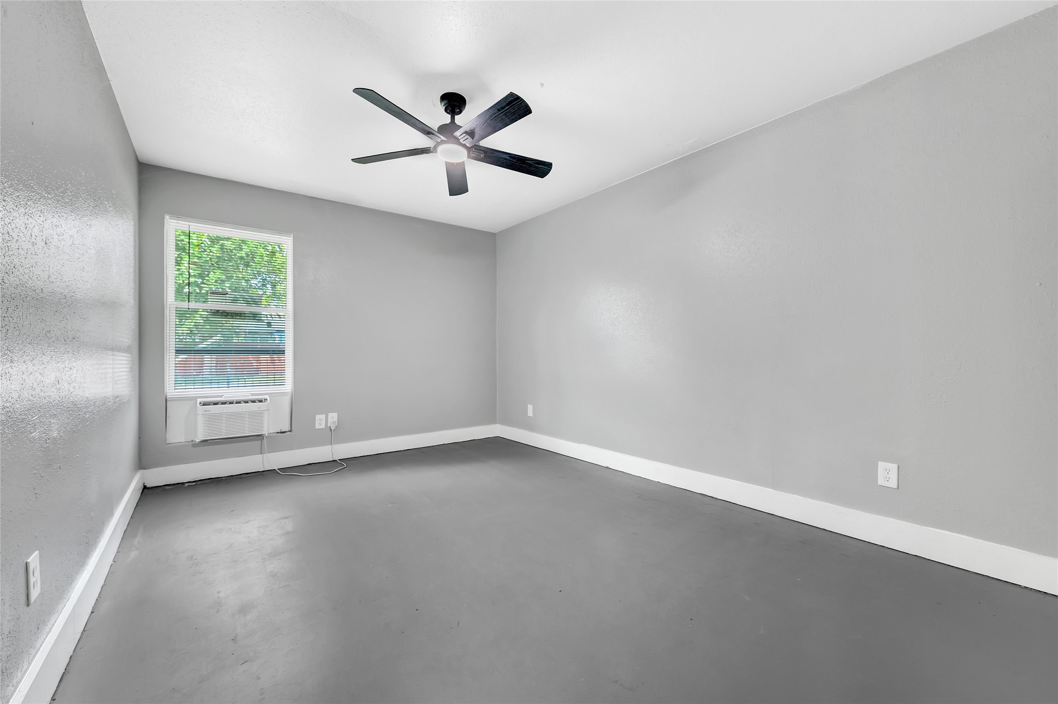 3802 Dabney Street, Unit 3 Houston, TX 77026 - Photo 9 of 13 an empty room with wooden floor fan and windows