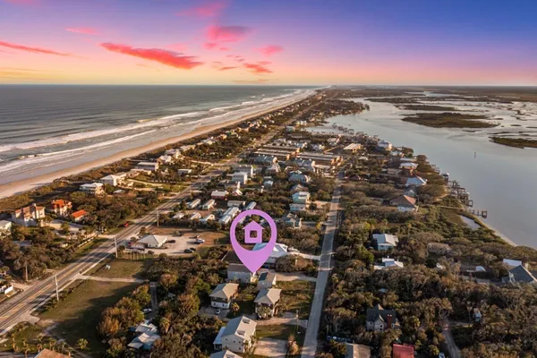 an aerial view of a brick house with sign broad