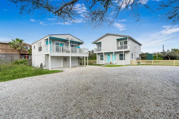 a view of a house with a yard and sitting area