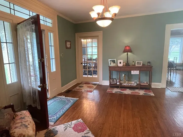 a living room with furniture and stairs with wooden floor