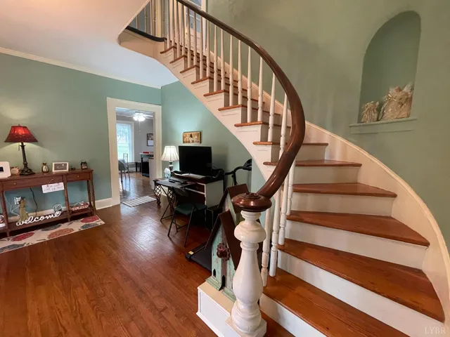 a view of entryway and hall with wooden floor