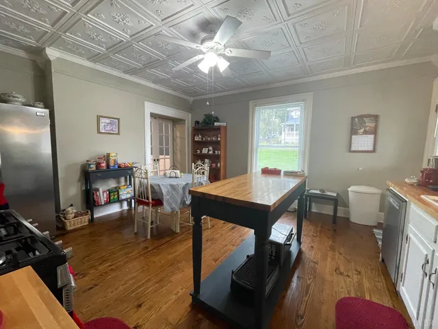 a view of a dining room with furniture and chandelier