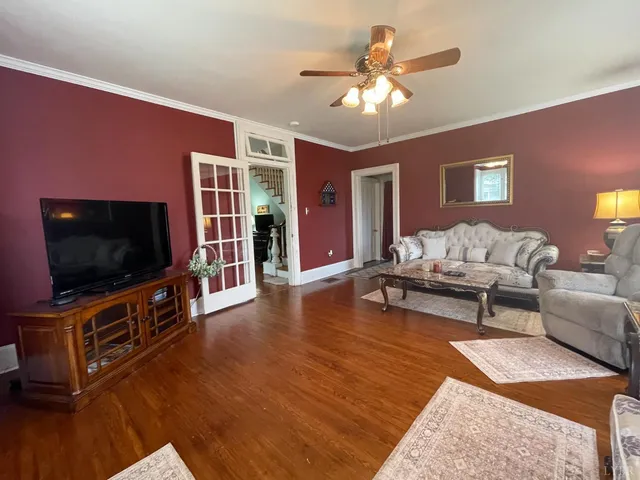 a view of a livingroom with furniture and a large window