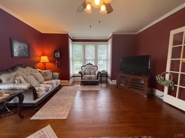 a living room with furniture a flat screen tv and a table
