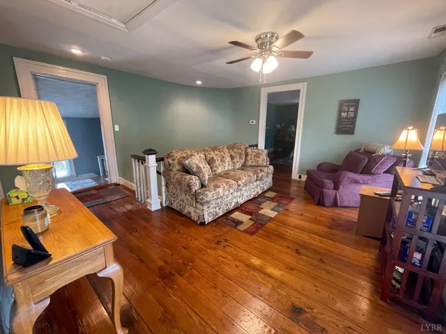 a view of a backyard with potted plants and large tree