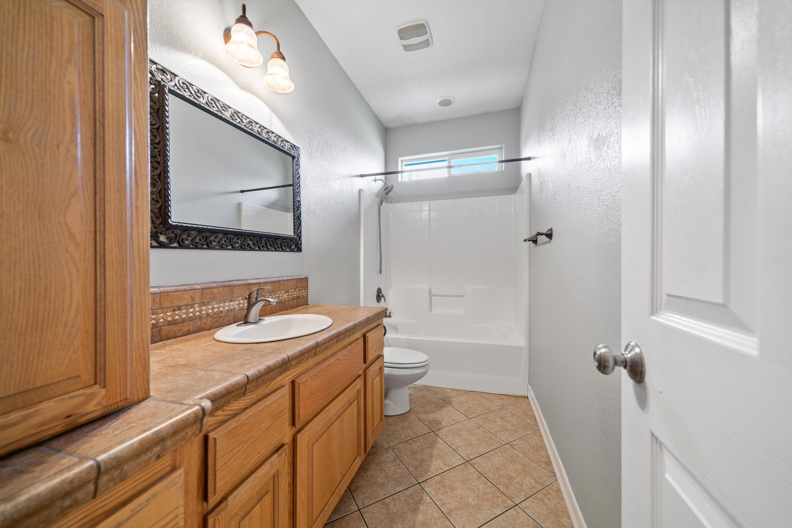 28321 Pimlico Way Tehachapi, CA 93561 - Photo 13 of 23 a bathroom with a sink a toilet and shower